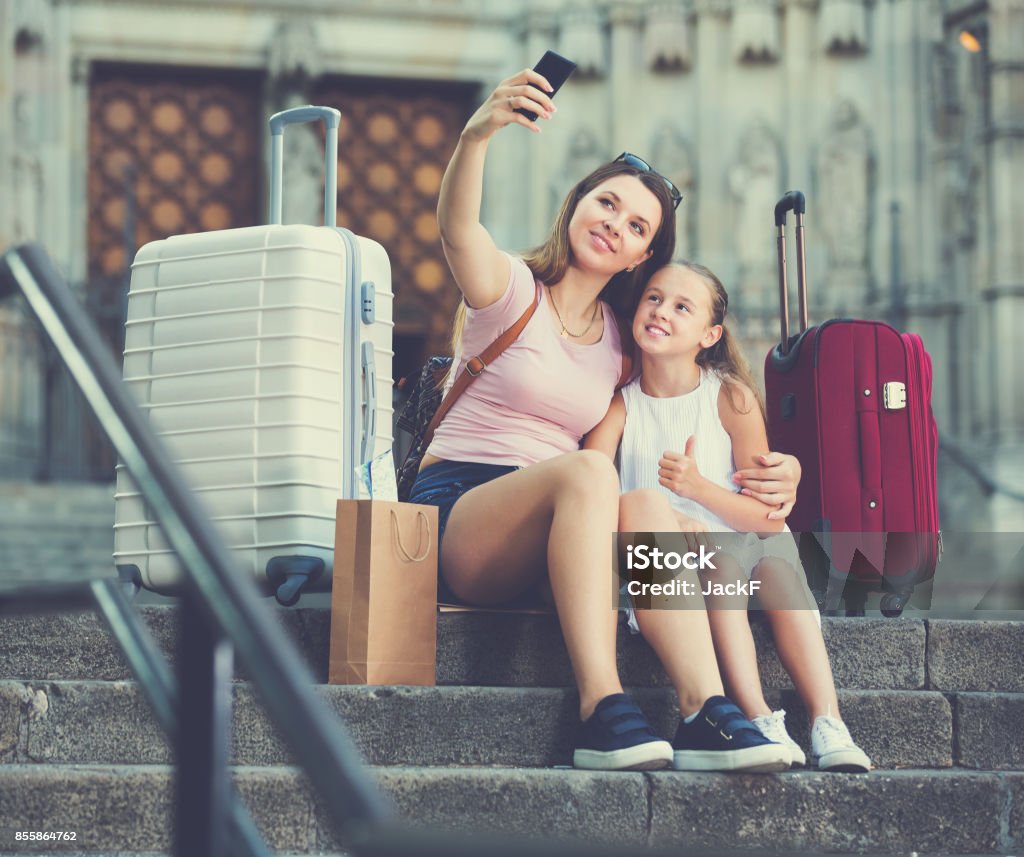 Female tourists taking selfie Young mother with little girl making selfie on European city during joint vacation 25-29 Years Stock Photo