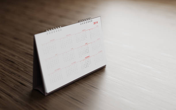 istock White 2018 Calendar Standing On  Brown Wood Surface 855876370