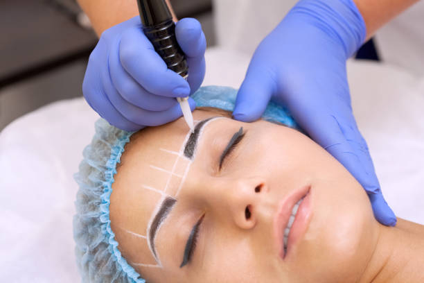 istock Permanent make-up for eyebrows of beautiful woman with thick brows in beauty salon. 855880256