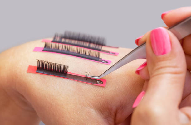 Eyelash removal procedure close up Eyelash removal procedure close up. False eyelashes on the hand of the make-up artist. lash and brow comb stock pictures, royalty-free photos & images