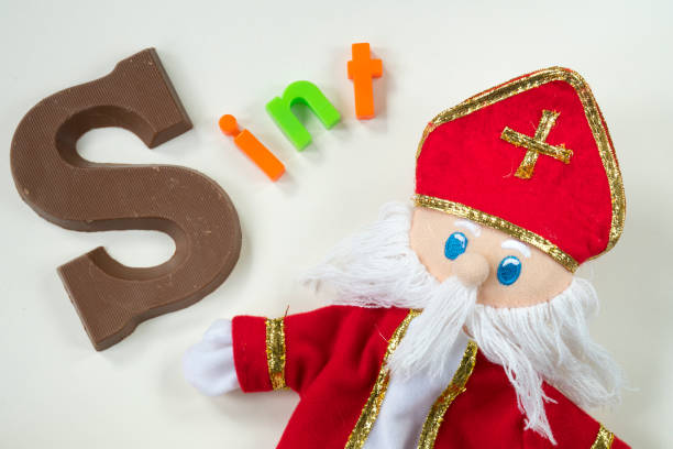 istock Dutch Sinterklaas doll, with chocolate letter, against white background, for St Nicholas event 855880368