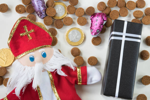 istock Dutch Sinterklaas doll, candy, ginger nuts, spiced biscuits, with chocolate letter, against white background, for the fifth of December, event-1 855880382