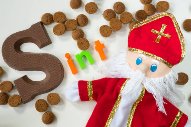 istock Dutch Sinterklaas doll, candy, gingernuts with chocolate letter, against white background, for Sinterklaas party 855882436