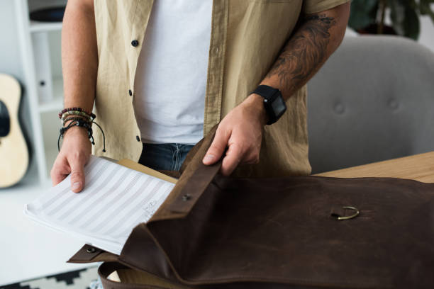 istock musician putting music notebook into bag 855882672