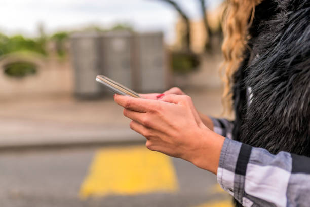 istock Attractive young woman texting on the street 855883634