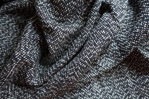 istock Rumpled salt and pepper woolen tweed fabric 855886802