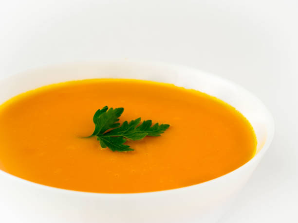 istock white bowl of pumpkin soup on white background 855887330