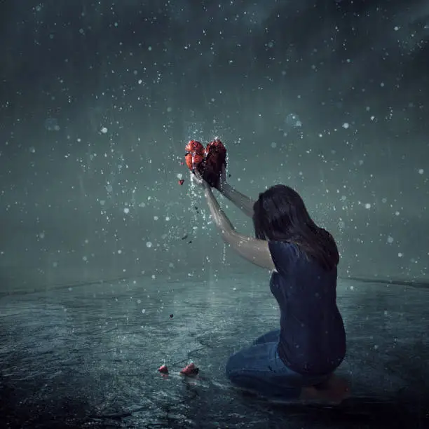 A woman offers up her broken heart during a rain storm