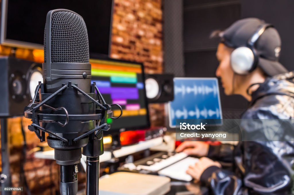 studio condenser microphone on sound engineer working in control room background. recording, broadcasting concept Recording Studio Stock Photo