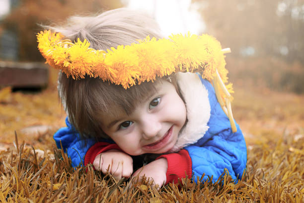 istock Little girl posing on camera walking in autumn park 855912604