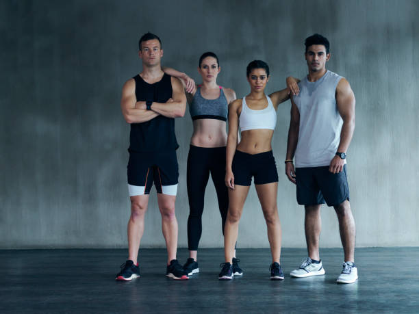 Full length portrait of a group of young athletes standing in the gym