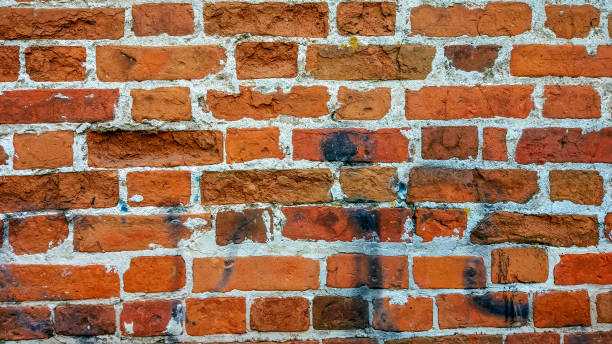 istock Brick wall made of red stone background. The spoiled brick is vintage. 855918554