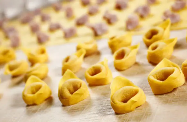 Tortellini. Italian homemade stuffed pasta made with fresh pasta kneaded with flour and eggs; stuffed with meat and parmesan cheese.
