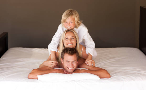 istock United family having fun together lying on bed 855918836