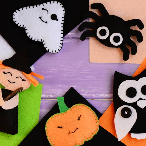 istock Halloween crafts made of felt. Felt witch, ghost, owl, spider, pumpkin decorations. Felt Halloween handmade decorations set. Sewing idea for adults and kids. Top view 855919284