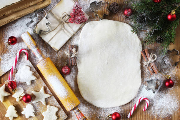 Cooking butter biscuits of different shapes on a wooden table