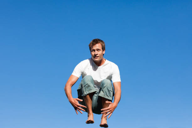 istock Young Man jumping in the air outdoor 855924242