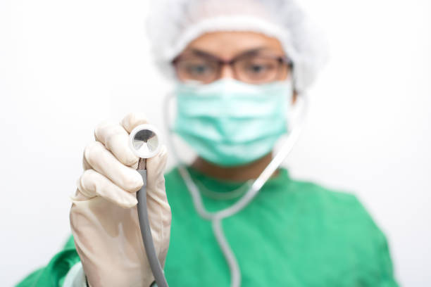 Portrait of confident female surgeon wearing scrubs in emergency room. Mature doctor is standing in operation theater. She is at hospital.