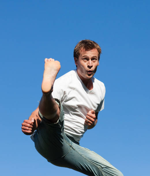 istock Smiling Man jumping in the air outdoor 855924368