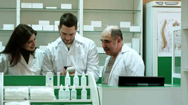 Smiling team of pharmacist at hospital pharmacy taking selfie