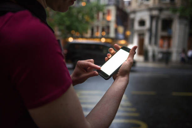 istock Woman looking at blank mobile phone screen with copy space. 855925318