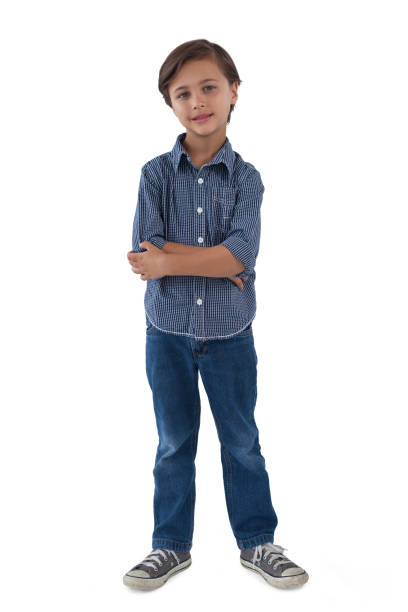 istock Boy standing with arms crossed against white background 855936702