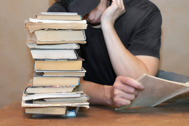 istock Man And Heap Of Books 855947200