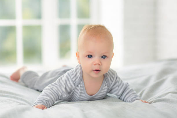 istock Portrait of a child four months on bed 855947782