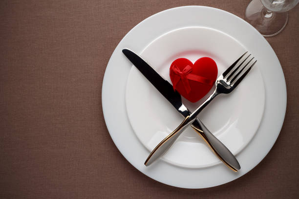 istock Valentines day table setting with red heart and cutlery on a plate. 855958428