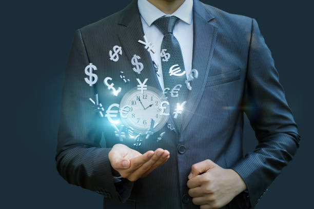 istock Wall clock and currency symbols shows the businessman . 855958578