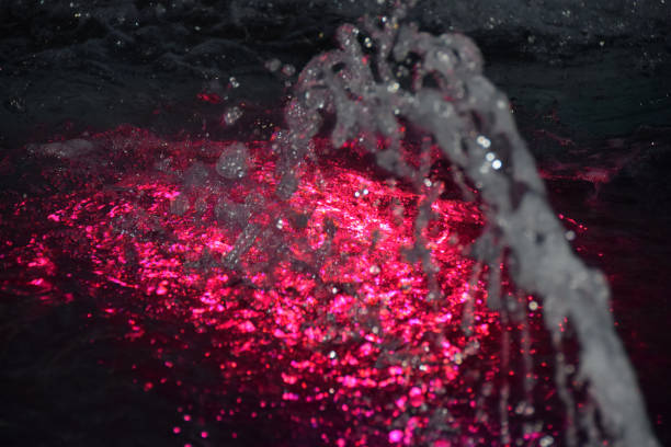 Pink light under the water surface in the pool