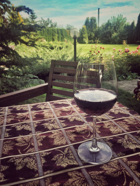 a wine glass on table at garden in summertime