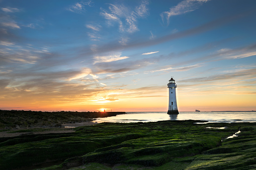 Sunset image of New Brighton lighthouse or Perch Rock which  is situated on the River Mersey and Liverpool Bay confluence.