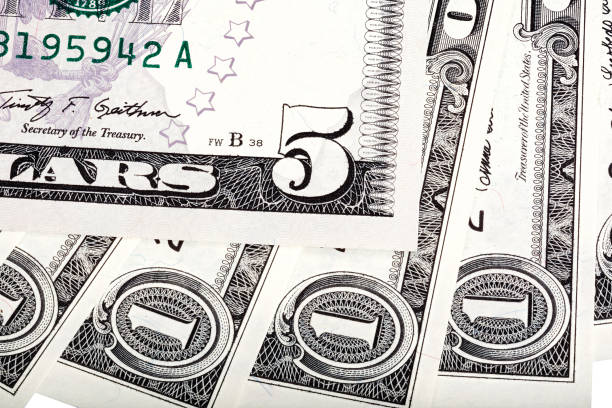 istock One dollar banknotes and five dollar bill abstract backgroun 855973512