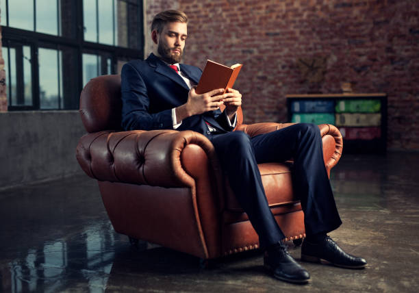 Businessman reading book stock photo