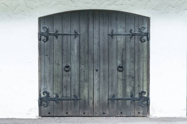 istock Old wooden garage door with ironwork 855984794