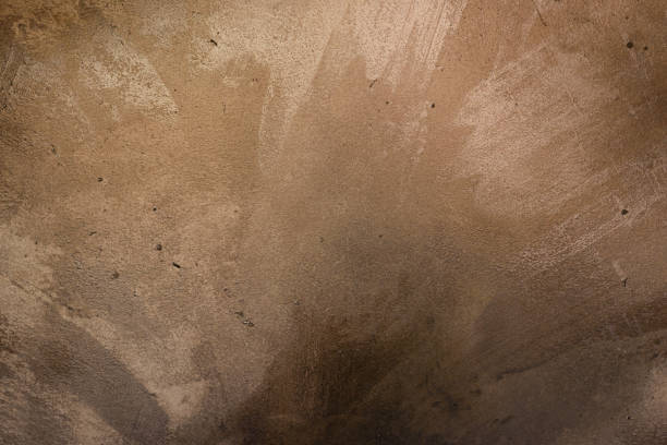 Metallic golden block tile with bolts floor reflecting bright light. Industrial abstract background concept.