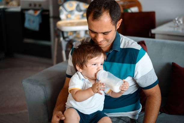 istock Father Feeding his Baby Boy with Milk Bottle 855993680