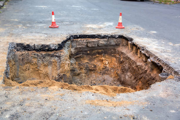 The road repair work. The road repair and caution with blocked barrier over concrete digging. sinkhole stock pictures, royalty-free photos & images