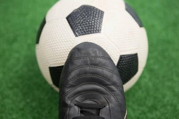 istock Football and cleats on artificial grass 856000474