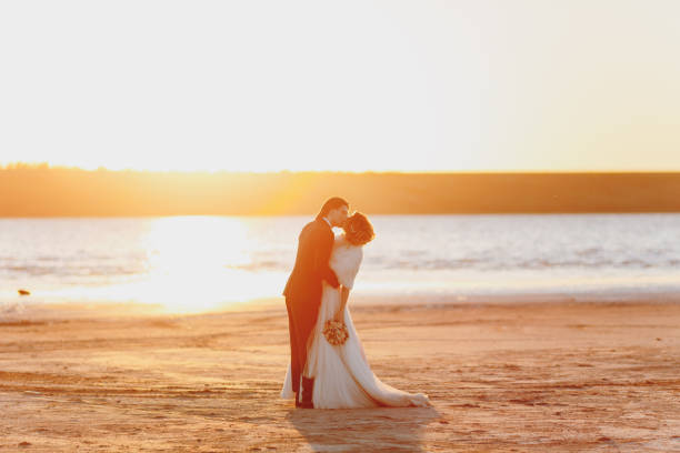 istock Groom and bride on a walk outdoors at the sea 856004362