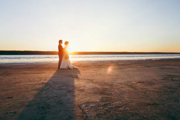 istock Groom and bride on a walk outdoors at the sea 856004564