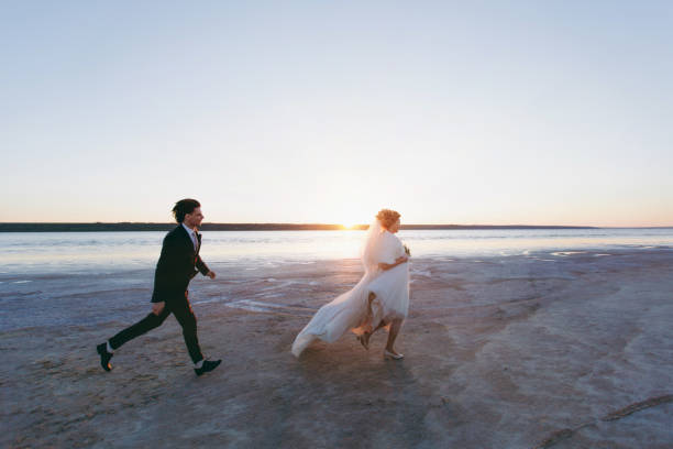 istock Groom and bride on a walk outdoors at the sea 856004684