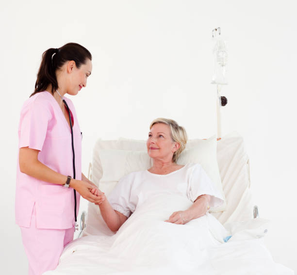 istock Beatiful nurse with a elderly woman 856007400