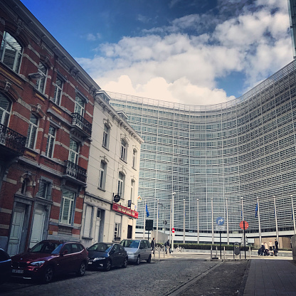 Brussels, Belgium - September 17, 2017: Brussels street with bar and European Commission building, few people on the street.