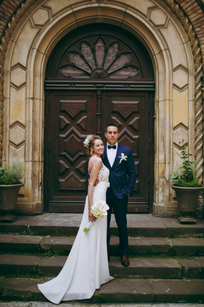 istock A wedding couple is standing on the steps of a building 856015246