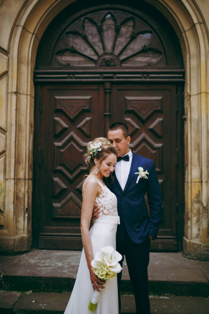 istock A wedding couple is standing on the steps of a building 856015294