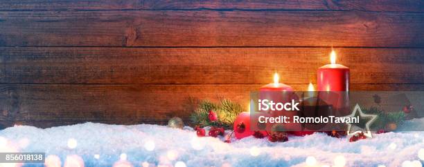 Advent Red Candles On Snow With Vintage Wood Stock Photo - Download Image Now - Advent, Candlelight, Banner - Sign