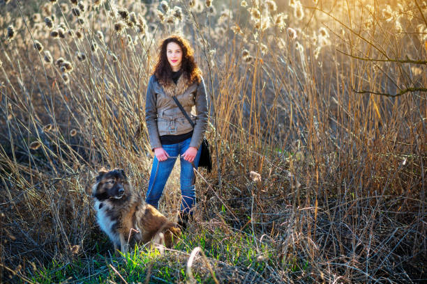 istock Girl playing with Caucasian shepherd dog, autumn 856020554