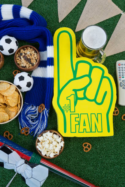 Foam hand, snacks and footballs on artificial grass Close-up of foam hand, snacks and footballs on artificial grass best american football free bet stock pictures, royalty-free photos & images